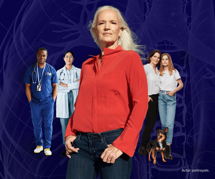 A serious women standing in front of two medical professionals and her family and dog. In the background of the image is an x-ray image of lungs.